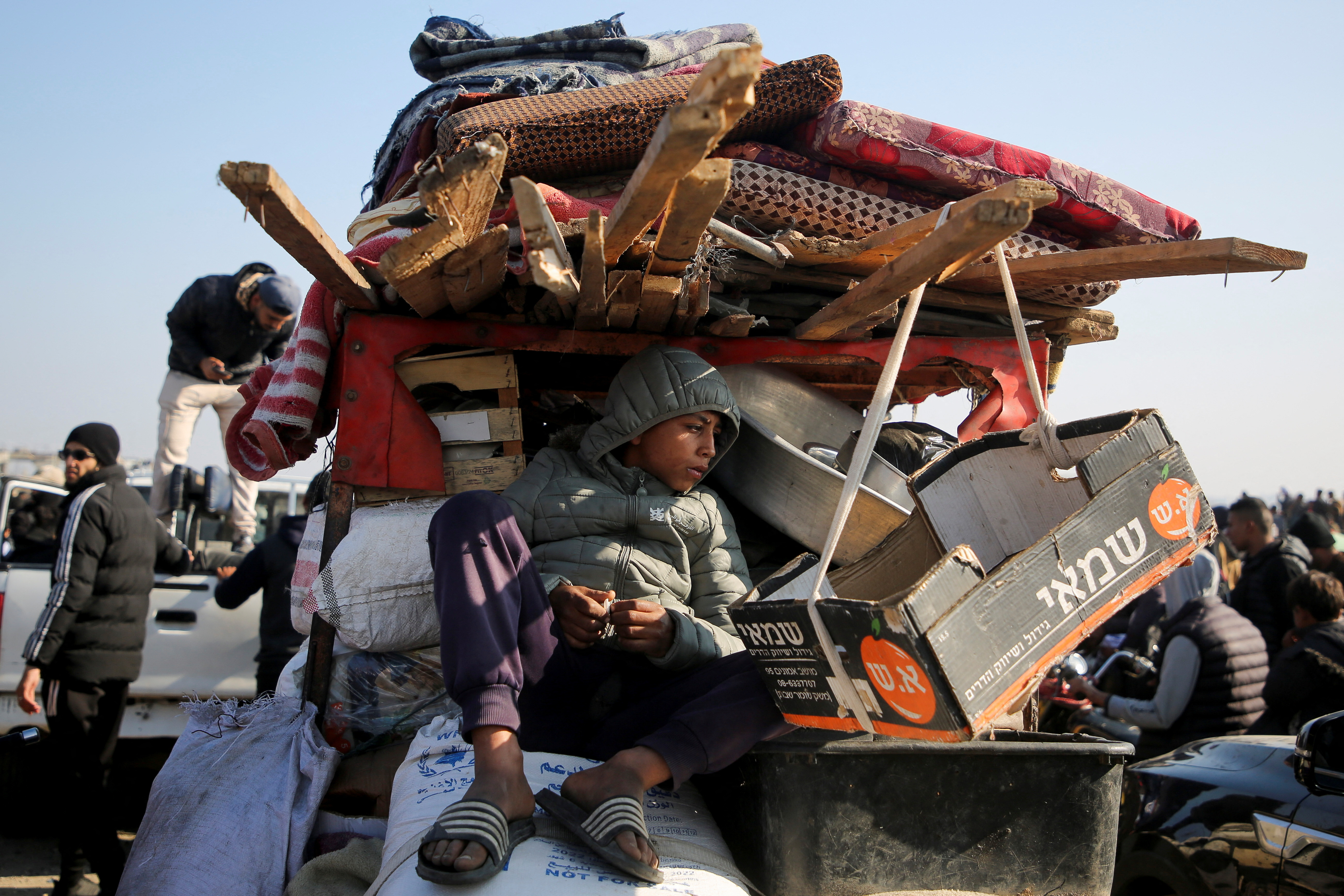 Displaced Palestinians make their way back to their homes in northern Gaza, amid a ceasefire between Israel and Hamas, in the central Gaza Strip