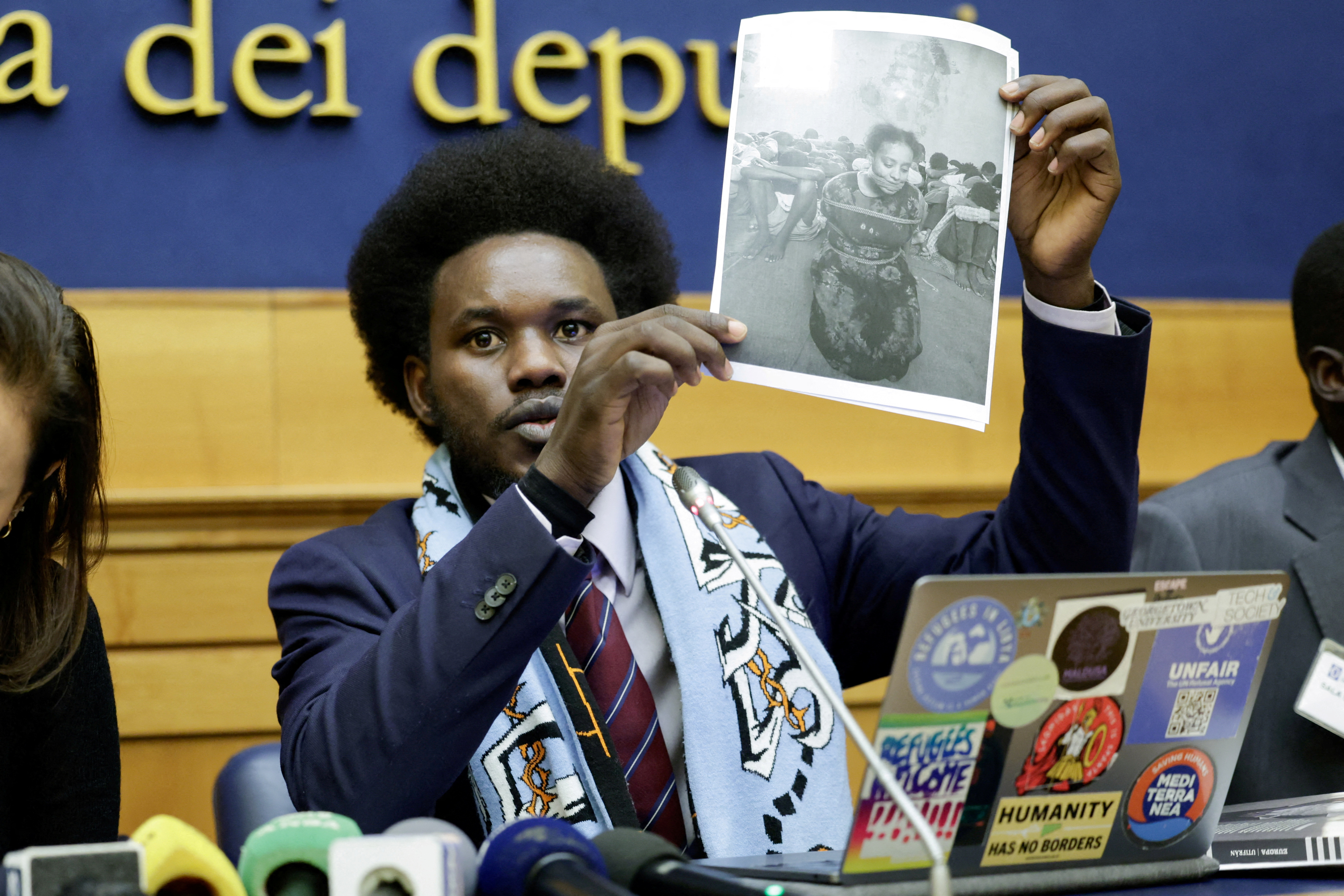 Migrants who were maltreated by Libyan ICC suspect Osama Elmasry Njeem hold a press conference in Rome