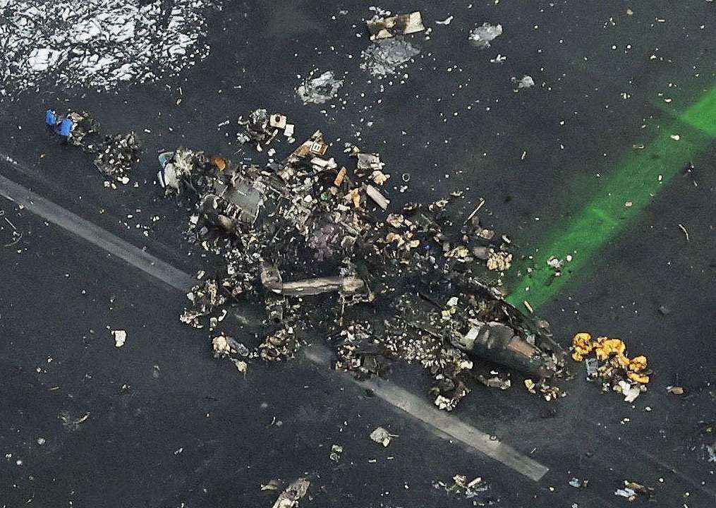 An aerial view shows burnt Japan Coast Guard aircraft after a collision with Japan Airlines' (JAL) Airbus A350 plane in Tokyo