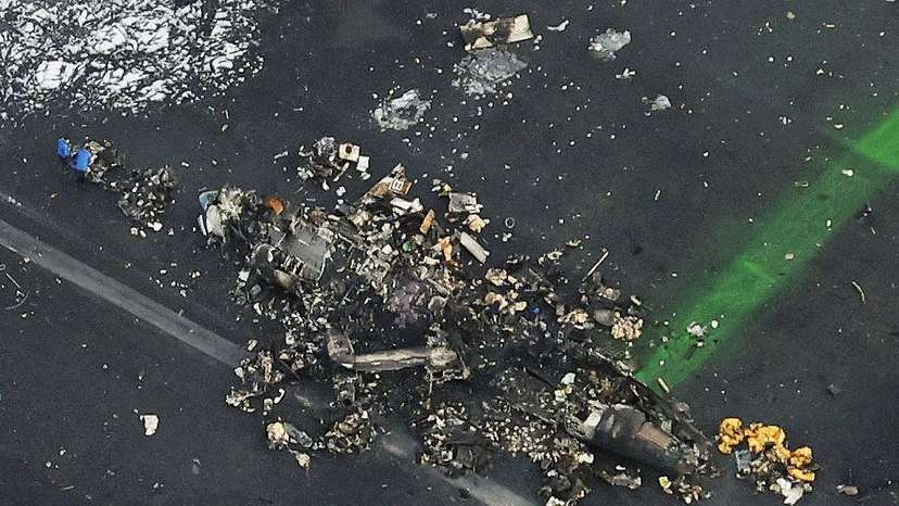 An aerial view shows burnt Japan Coast Guard aircraft after a collision with Japan Airlines' (JAL) Airbus A350 plane in Tokyo