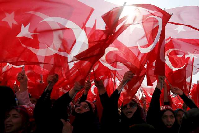 Women wave Turkey's national flags during a rally against recent Kurdish militant attacks on Turkish security forces in Istanbul