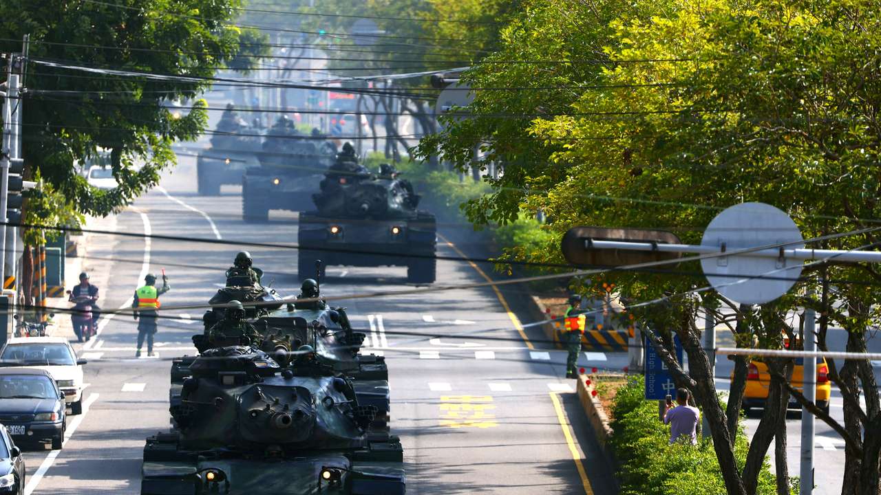FILE PHOTO: Soldiers drive M60 tanks on a street as part of a military drill in Taichung