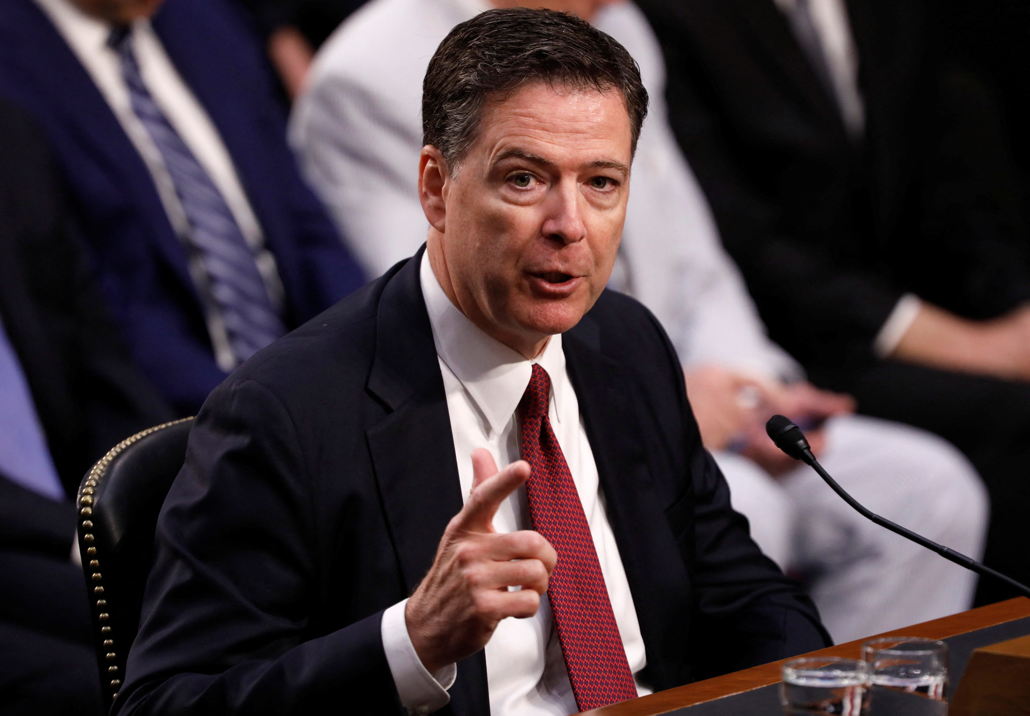 FILE PHOTO: Former FBI Director Comey testifies before a Senate Intelligence Committee hearing in Washington