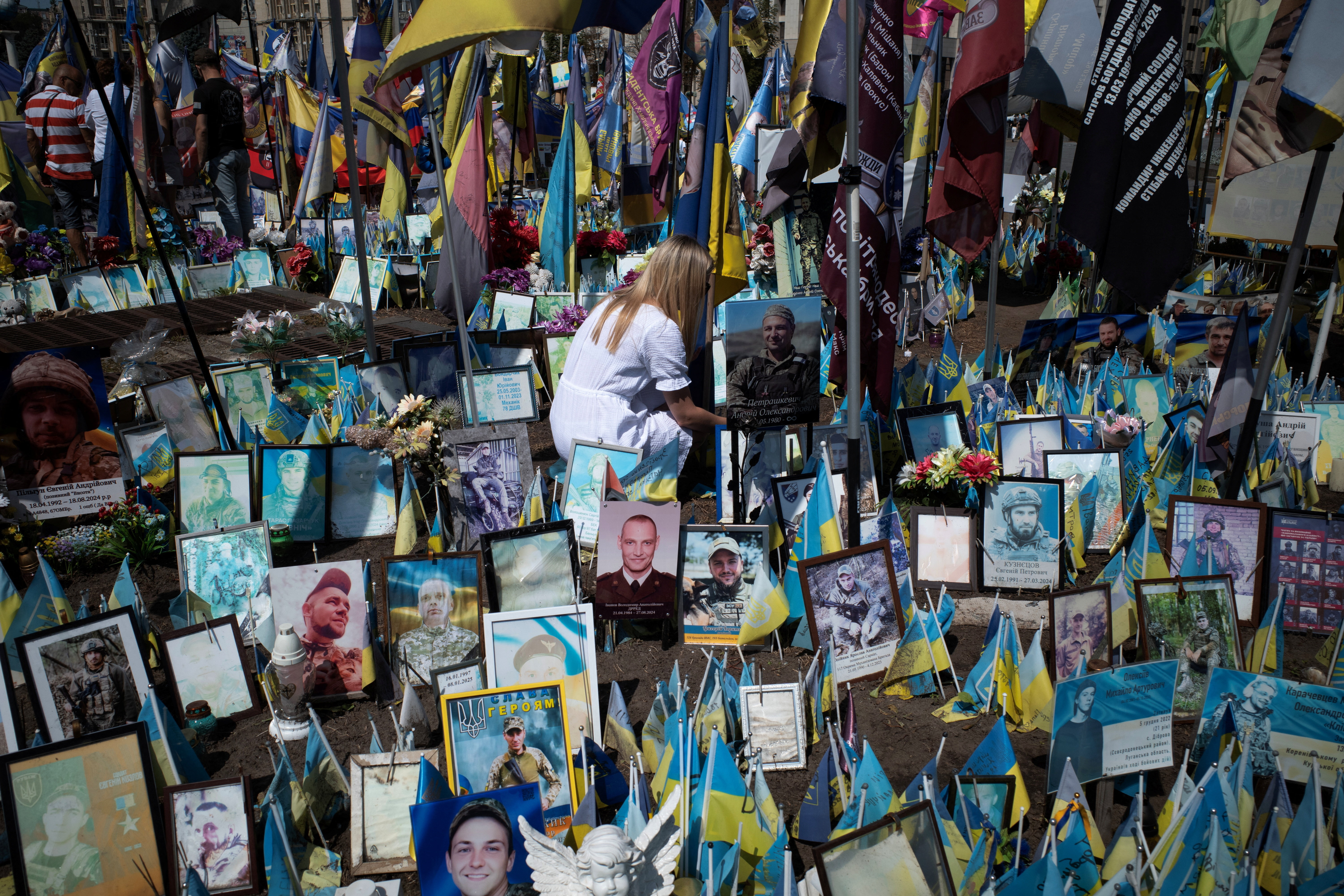 A woman pays tribute to a fallen soldier In Kyiv's Maidan Square