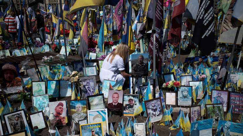 A woman pays tribute to a fallen soldier In Kyiv's Maidan Square