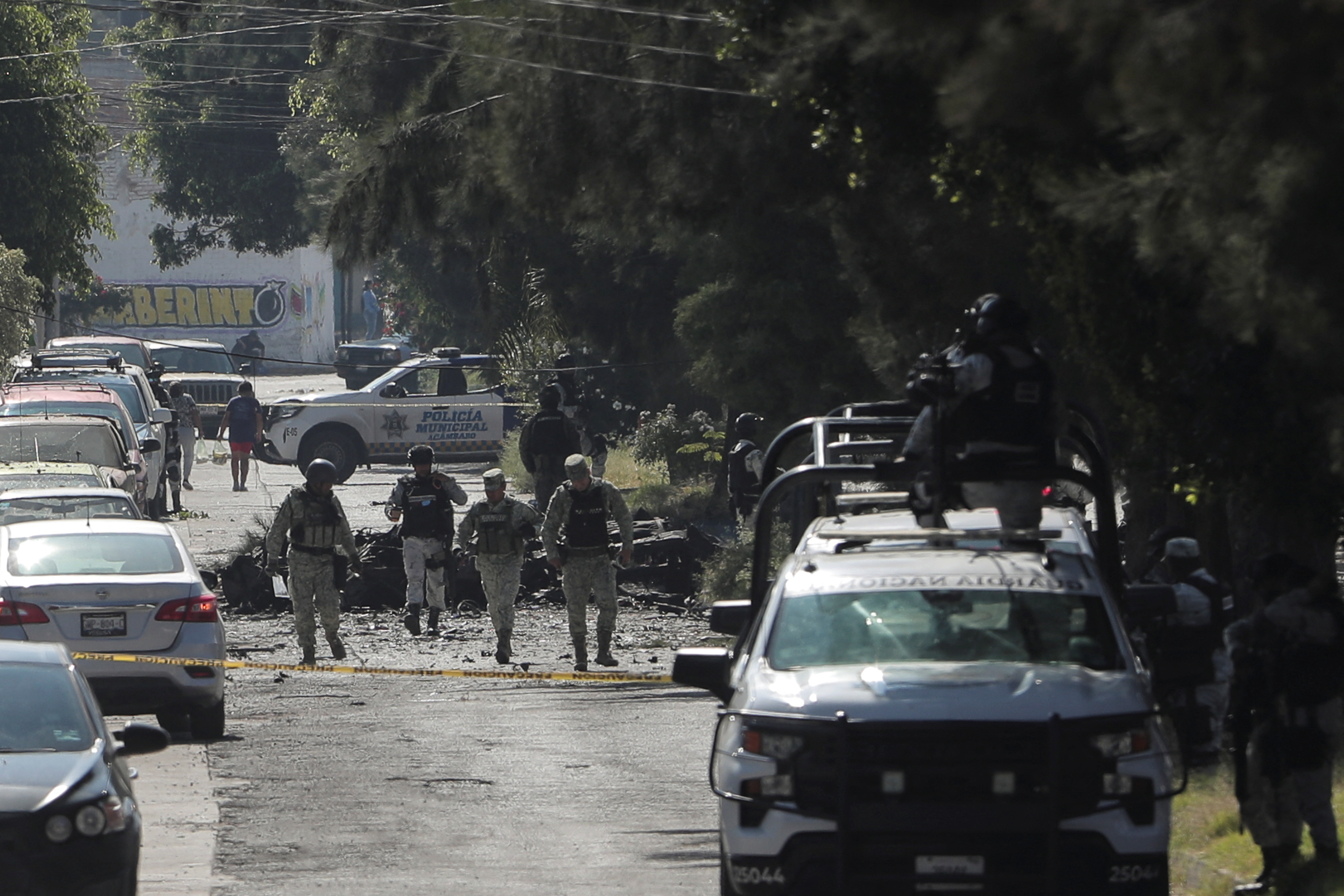 Federal forces work at the scene of a car bomb in Acambaro