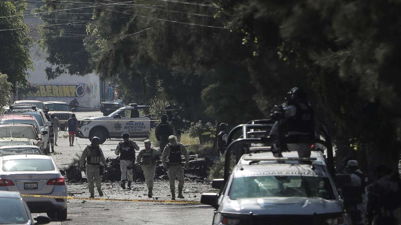 Federal forces work at the scene of a car bomb in Acambaro