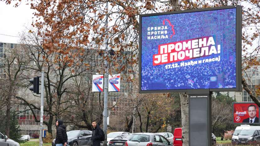People stand next to a pre-election billboard of opposition coalition 'Serbia Against Violence' in Belgrade