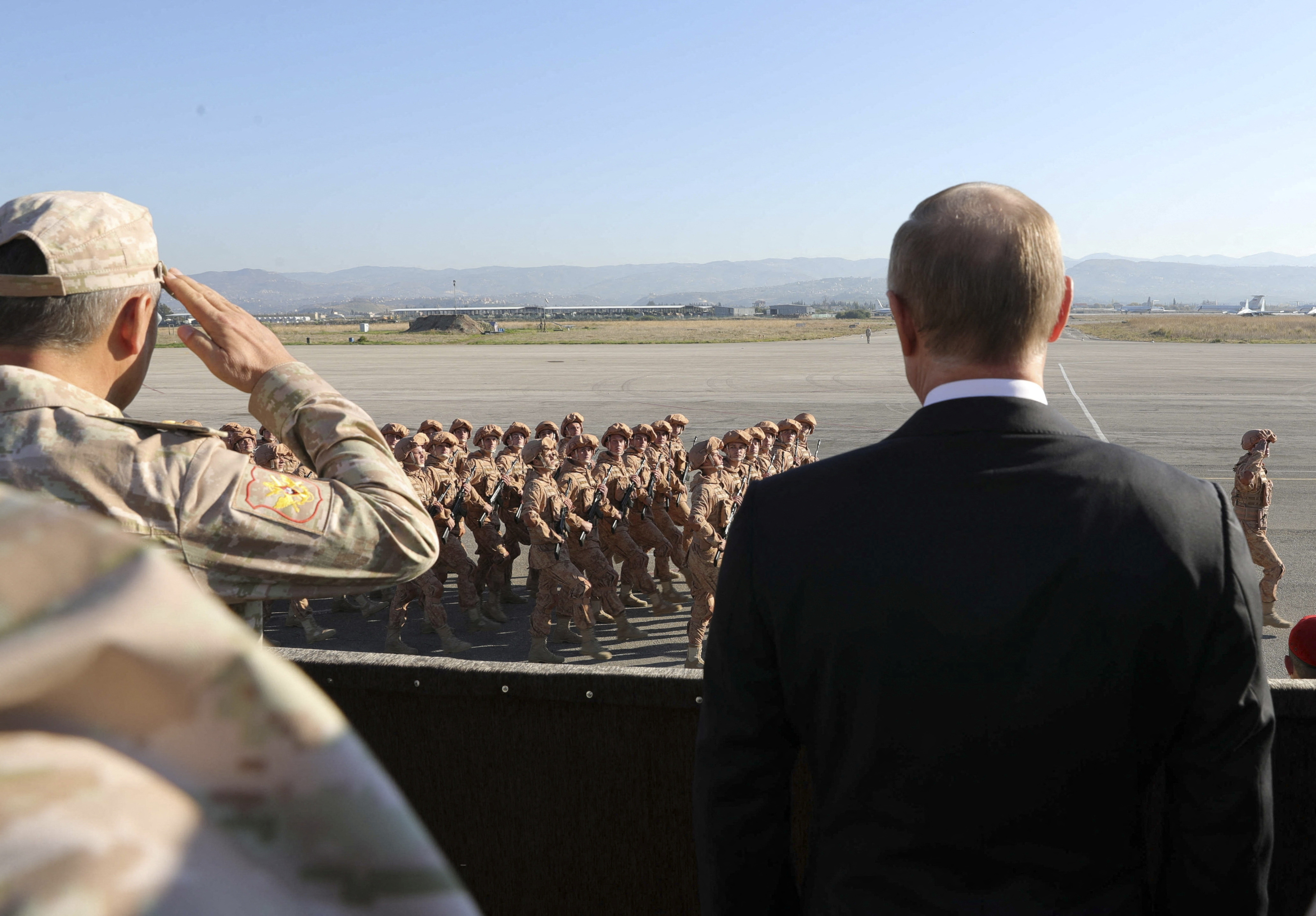 FILE PHOTO: Russian President Putin and then Defence Minister Shoigu visit the Hmeymim air base in Latakia Province