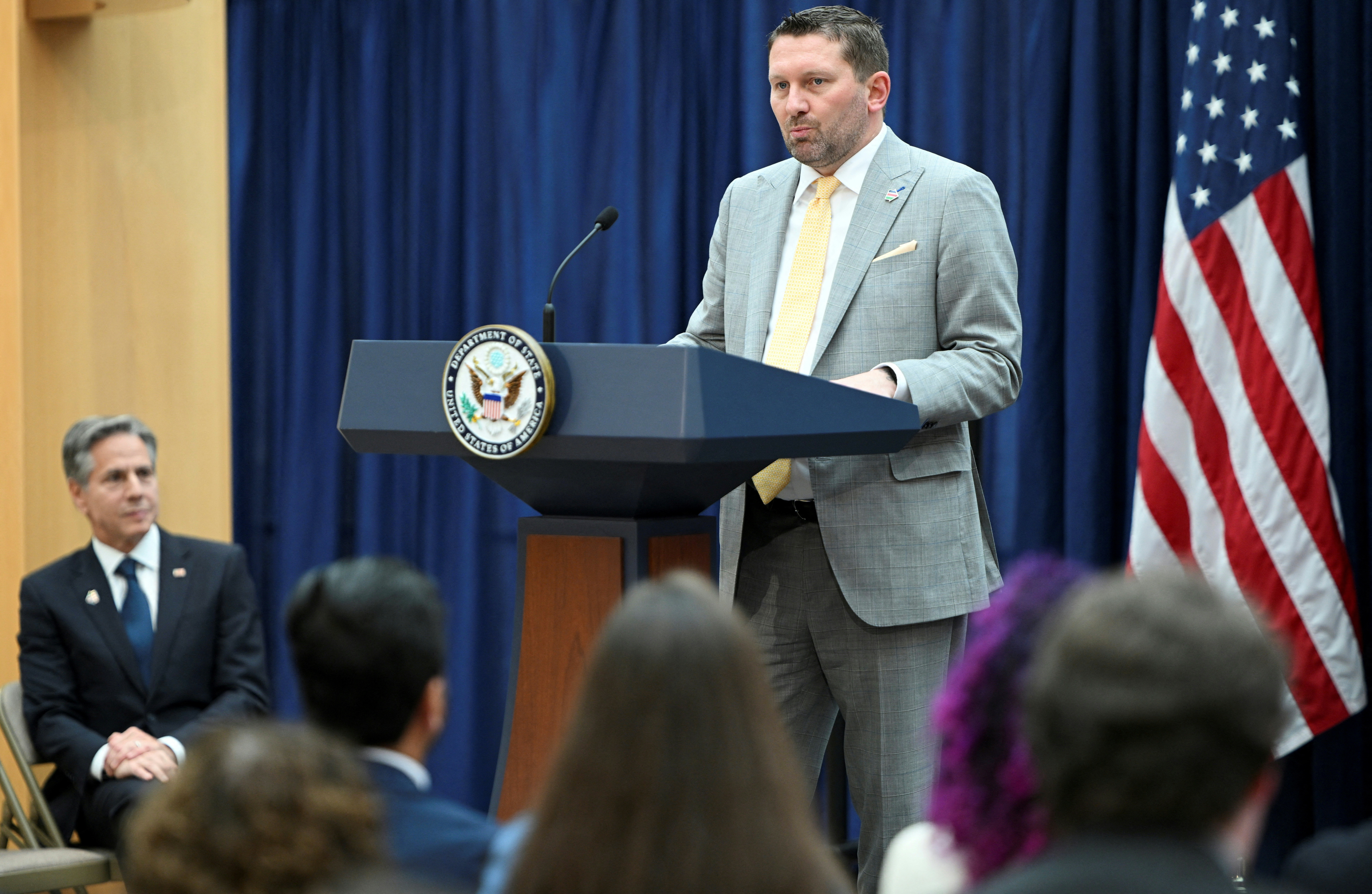 U.S. Secretary of State Antony Blinken looks on as AfghanEvac founder Shawn VanDiver speaks during a Memorandum of Understanding signing in Washington