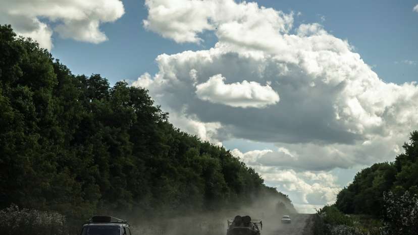 Ukrainian service members ride an Armoured Personnel Carrier near the Russian border in Sumy region