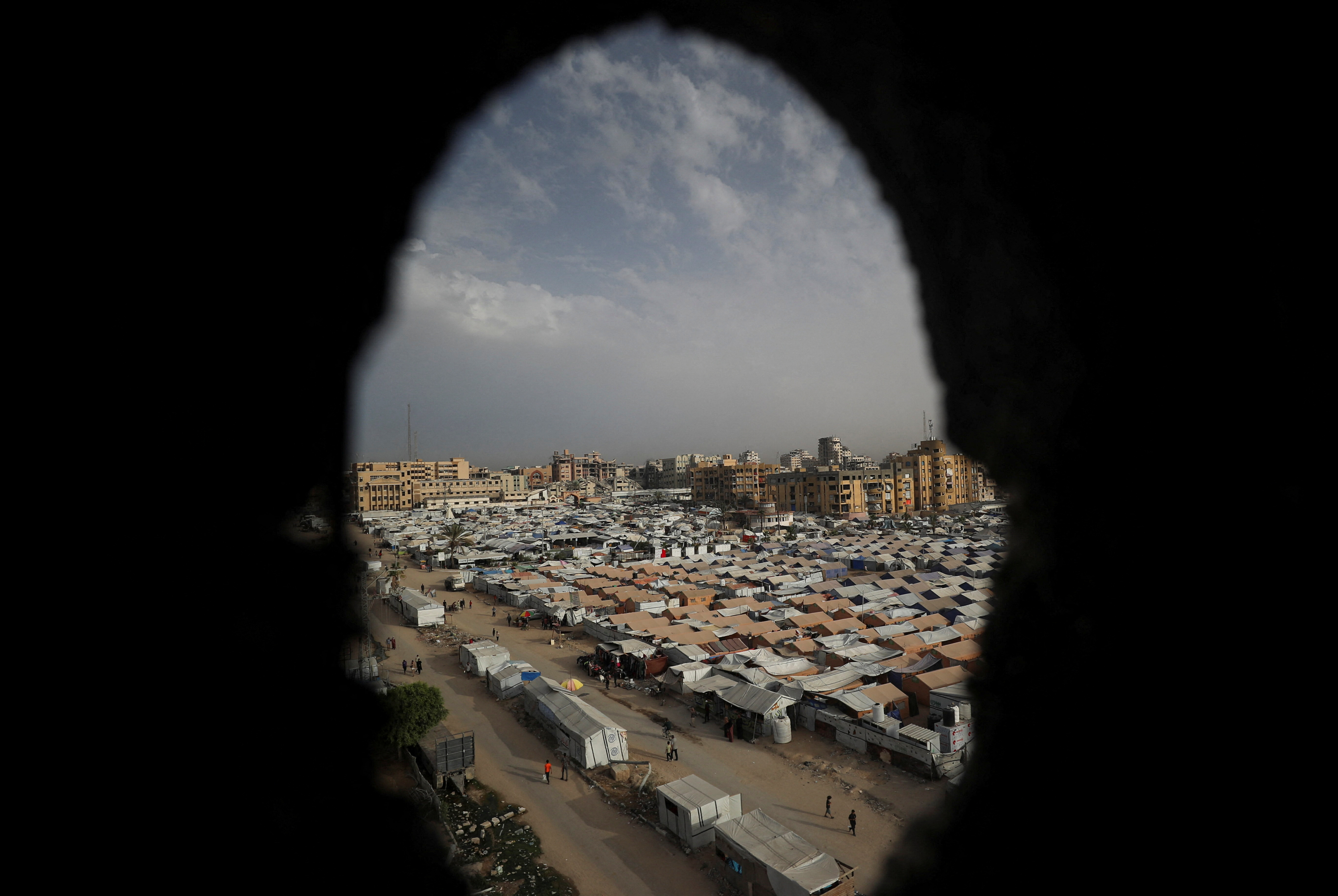 Palestinians displaced by the Israeli military offensive take shelter in tents, in Gaza
