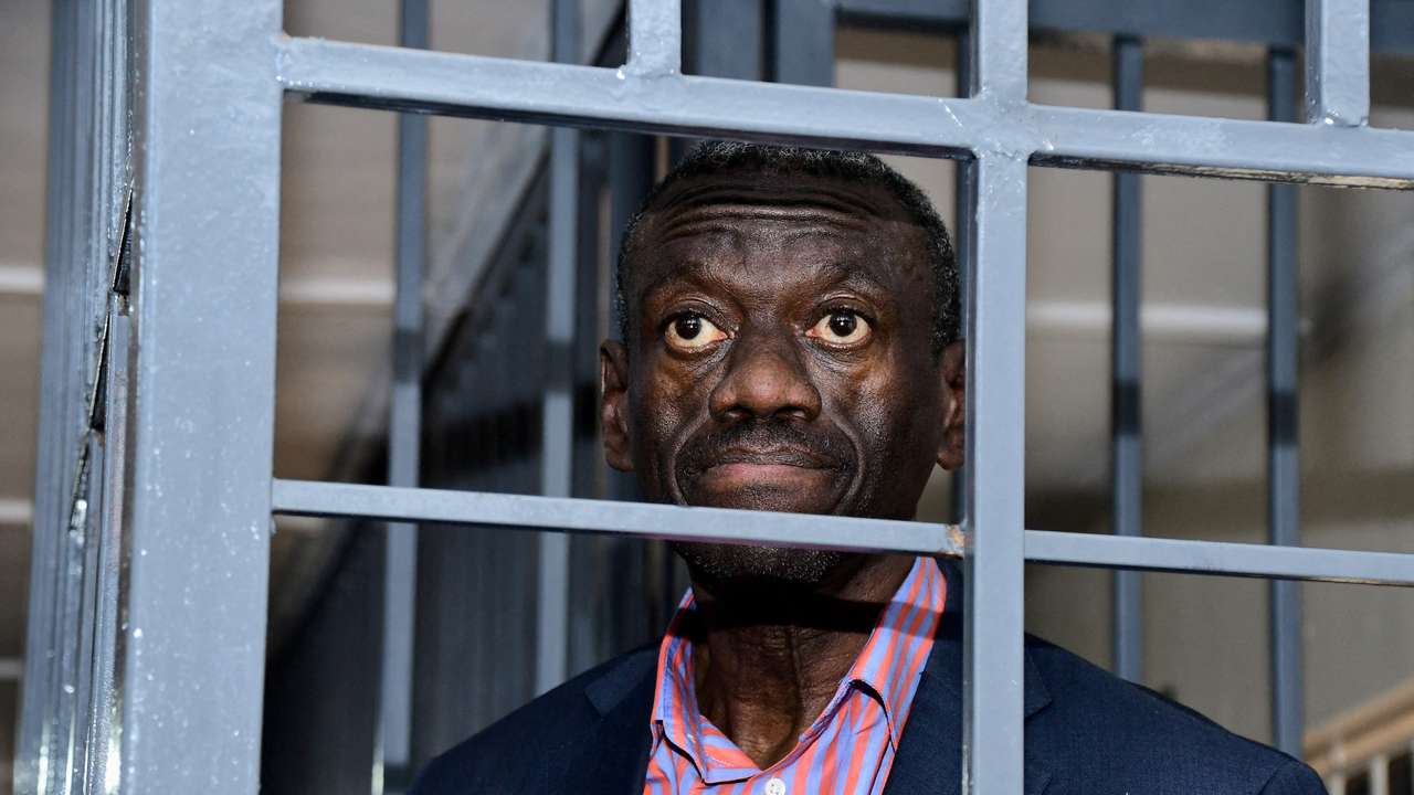 Ugandan four-time presidential aspirant Kizza Besigye stands in dock at the Uganda Military General Court Martial in Kampala