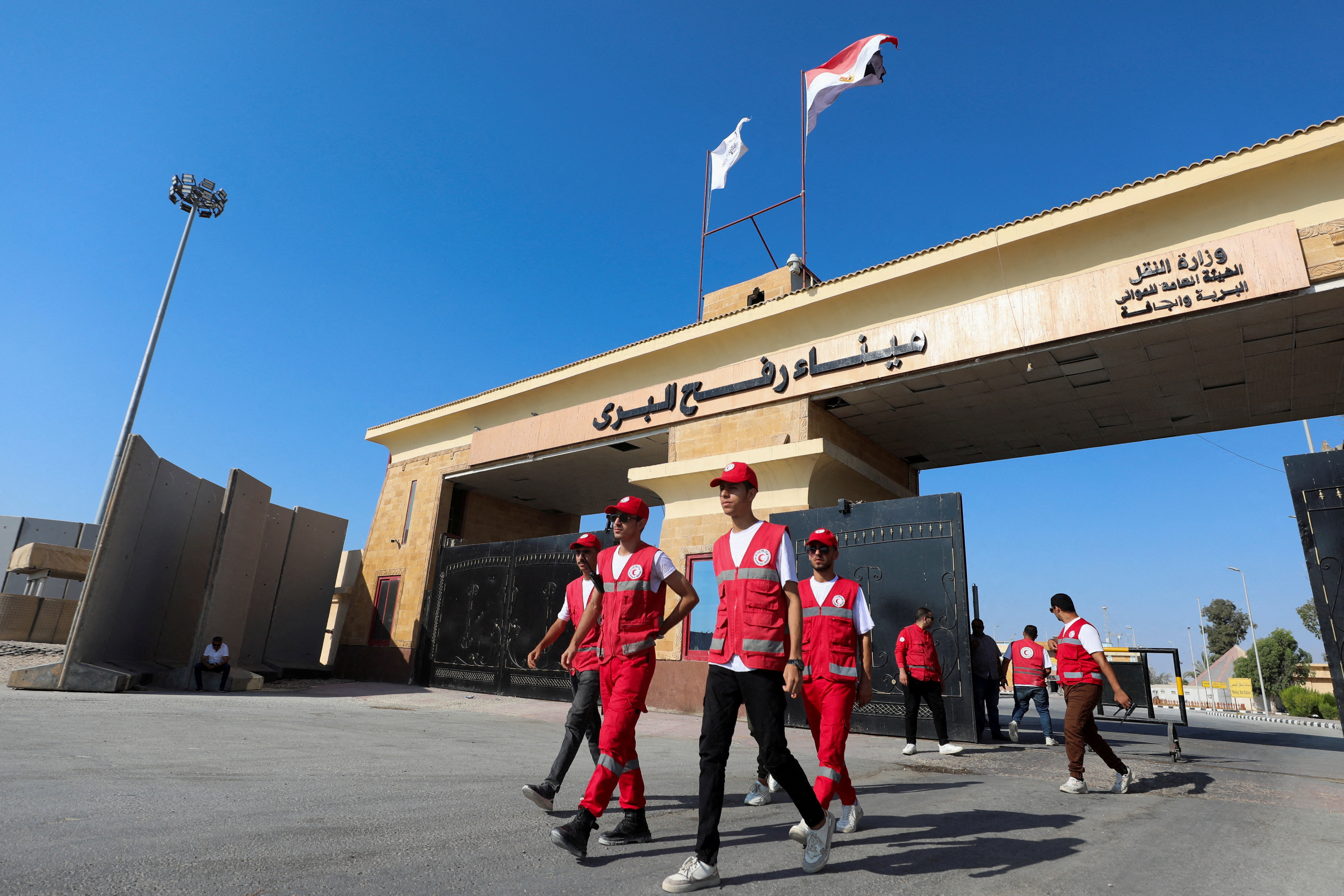 FILE PHOTO: Members of the Red Crescent walk at the Rafah border crossing between Egypt and the Gaza Strip, in Rafah