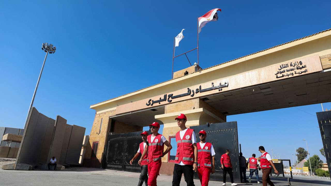 FILE PHOTO: Members of the Red Crescent walk at the Rafah border crossing between Egypt and the Gaza Strip, in Rafah