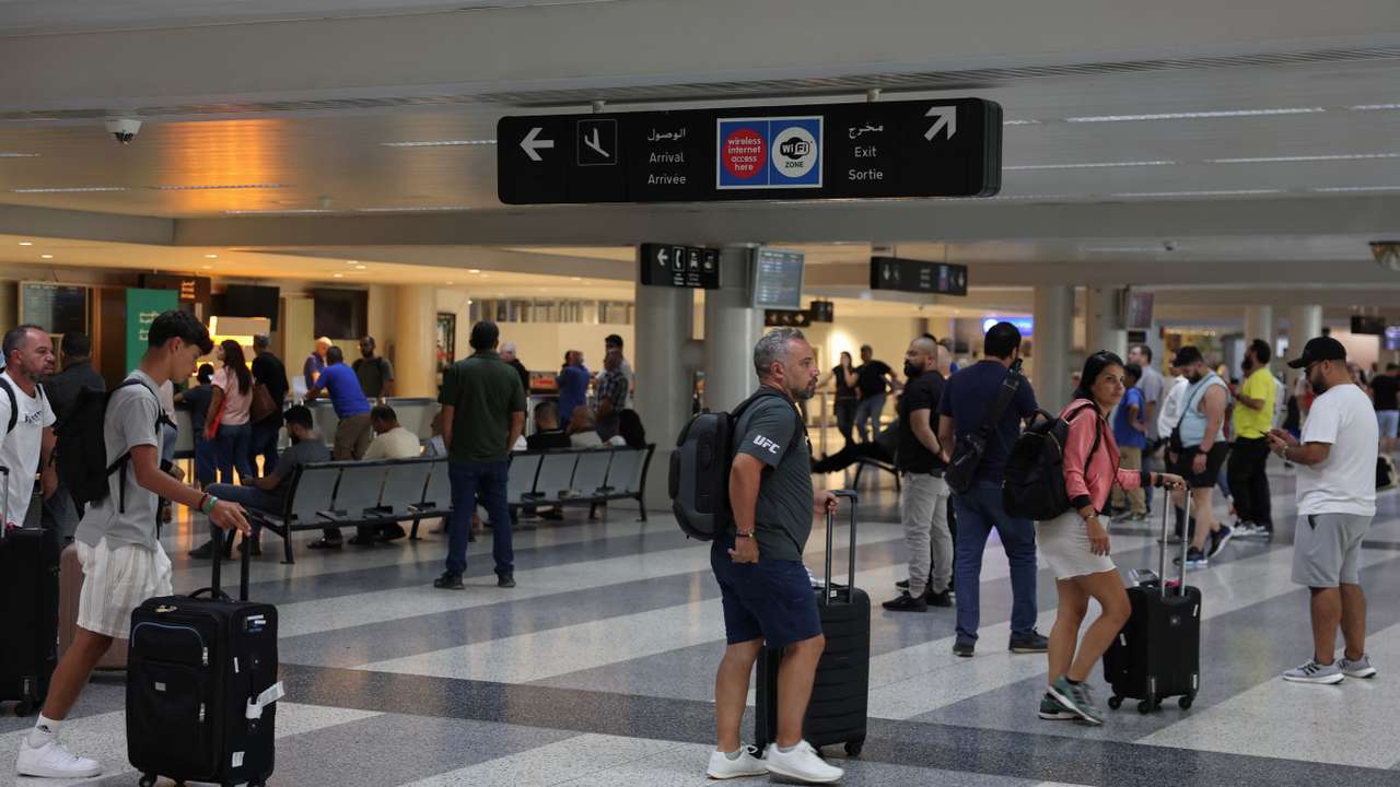 People walk with their luggages at Beirut-Rafic Hariri International Airport, in Beirut