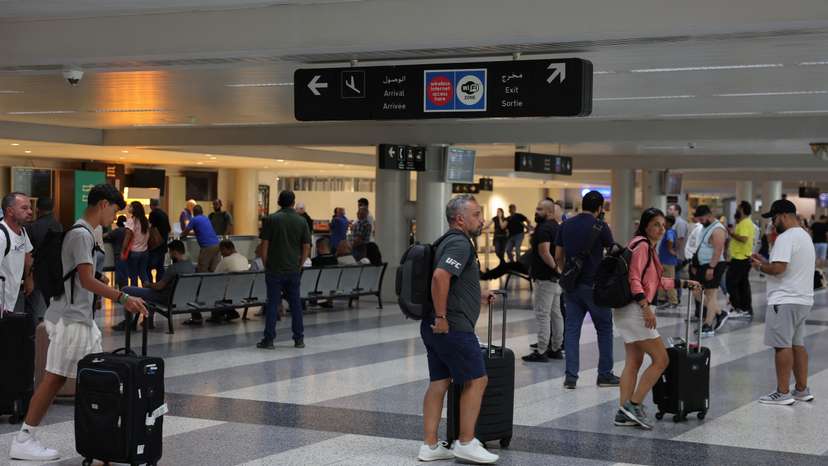 People walk with their luggages at Beirut-Rafic Hariri International Airport, in Beirut