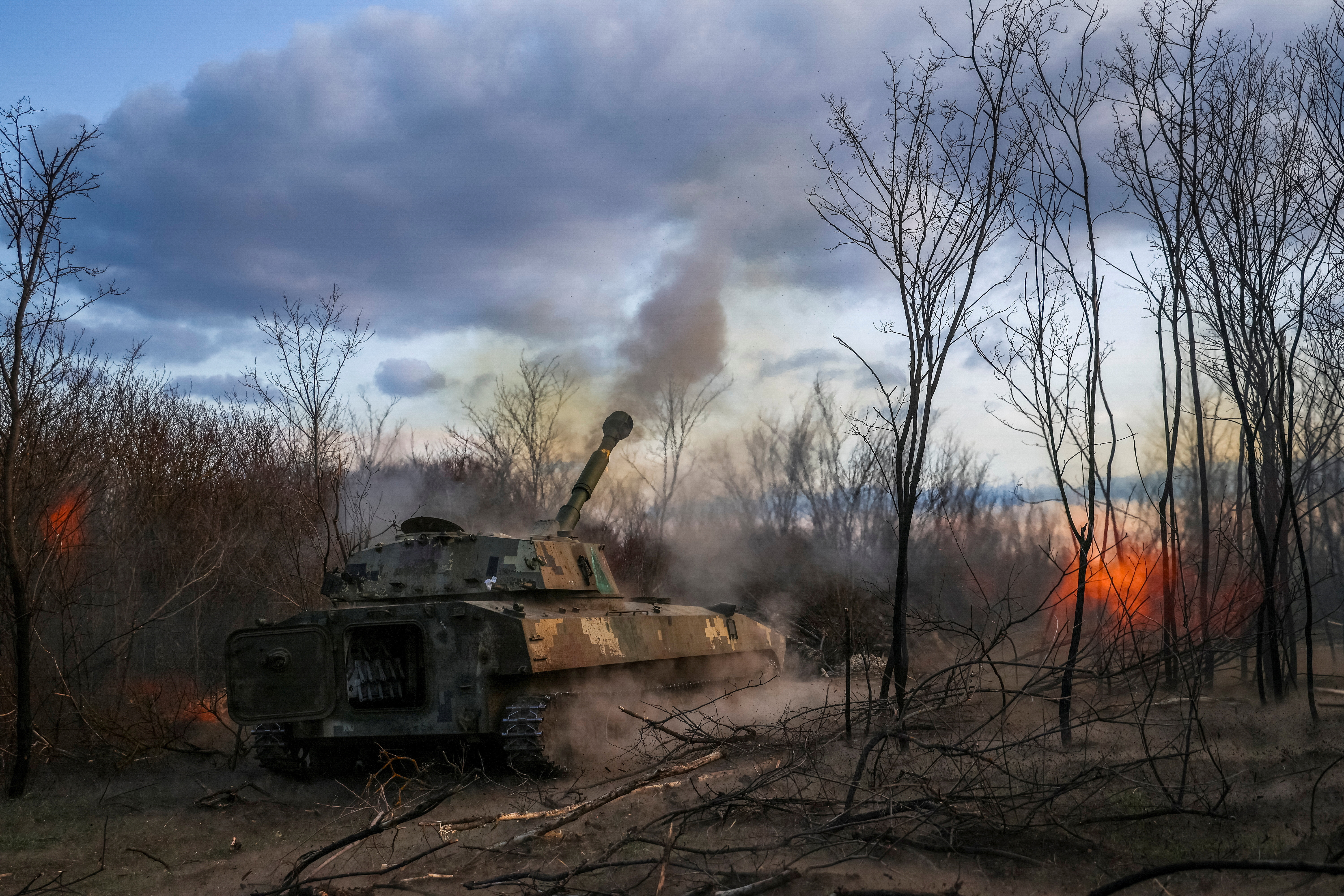 FILE PHOTO: Ukrainian servicemen fires a self-propelled howitzer towards Russian troops in a front line in Kherson region