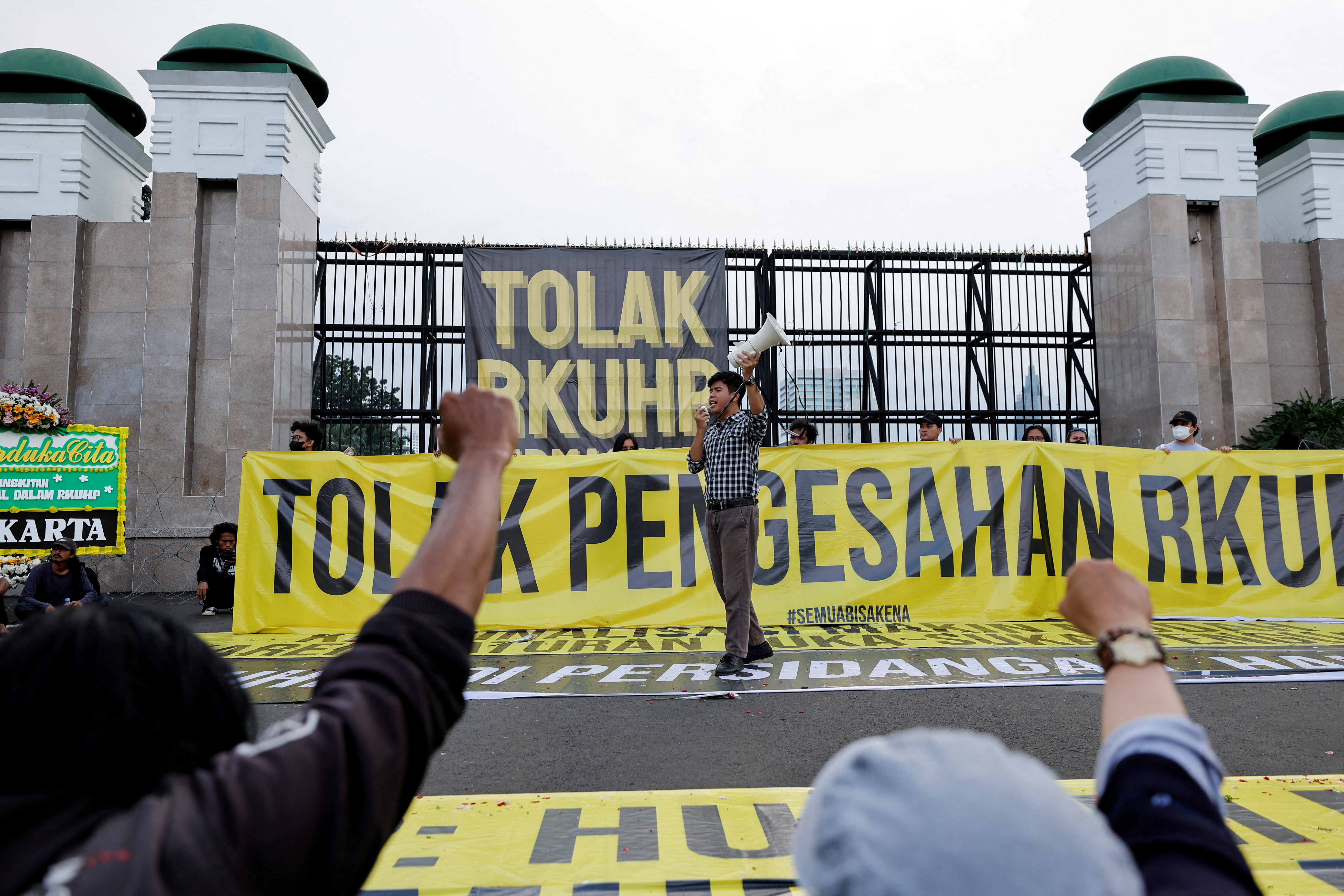 FILE PHOTO: People protest against a new criminal code in Jakarta