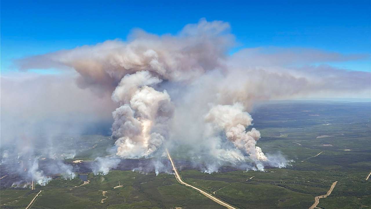 Smoke rises from wildfire SWF076, which forced the evacuation of the nearby town of Swan Hills
