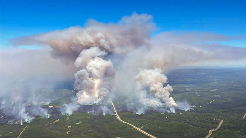 Smoke rises from wildfire SWF076, which forced the evacuation of the nearby town of Swan Hills