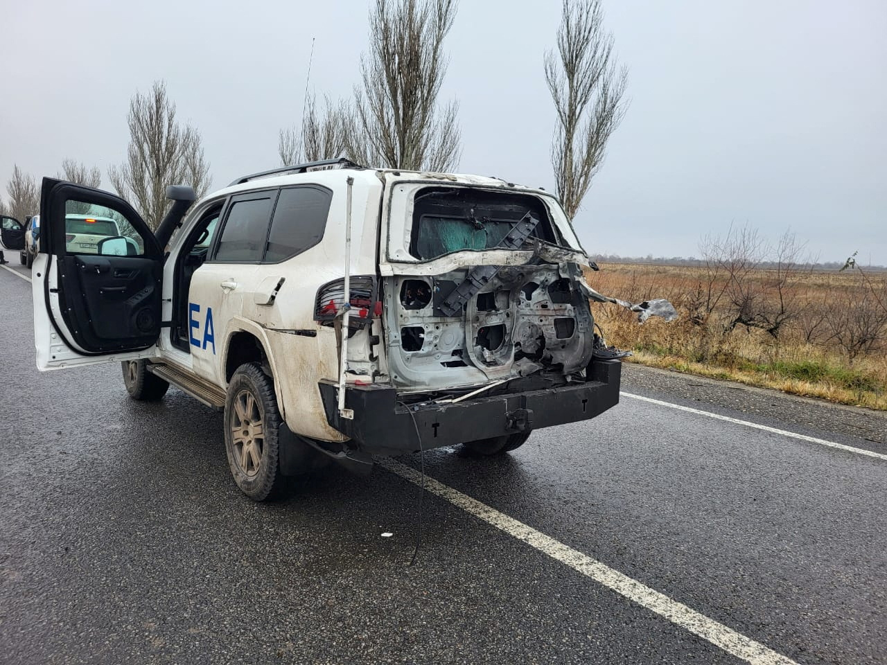 Official vehicle of the IAEA damaged by a drone strike is seen on a road in Zaporizhzhia region