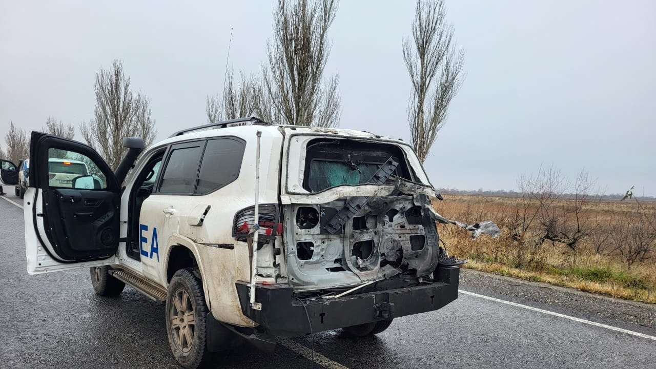 Official vehicle of the IAEA damaged by a drone strike is seen on a road in Zaporizhzhia region