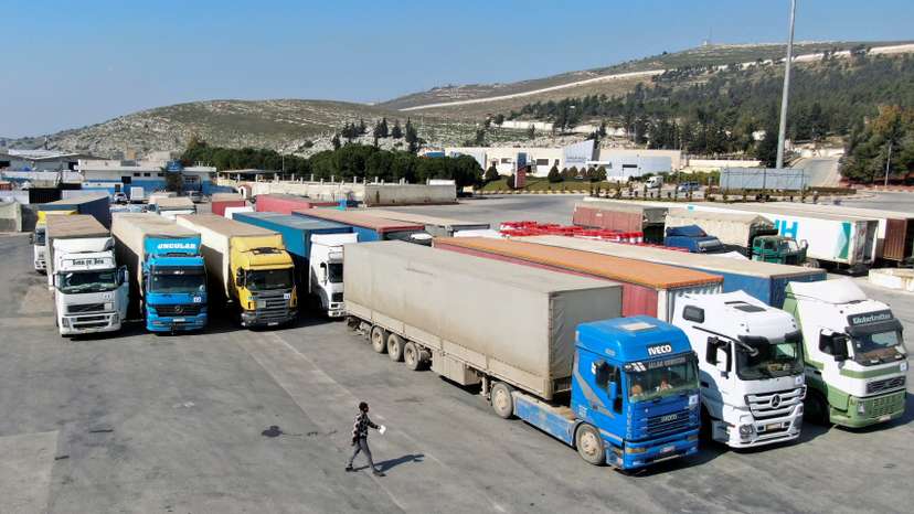 Trucks carrying aid from UN World Food Programme (WFP) are parked at Bab al-Hawa crossing