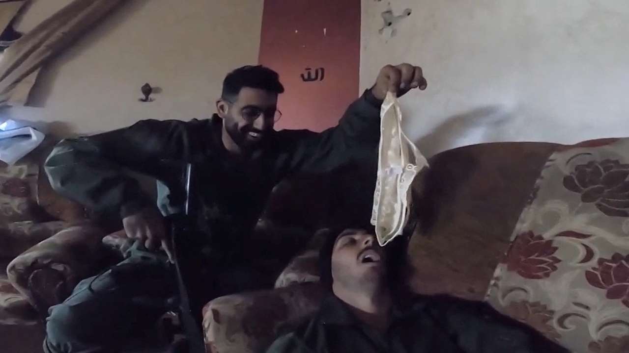 An Israeli soldier holds underwear over the face of a fellow Israeli soldier in a screengrab from a video