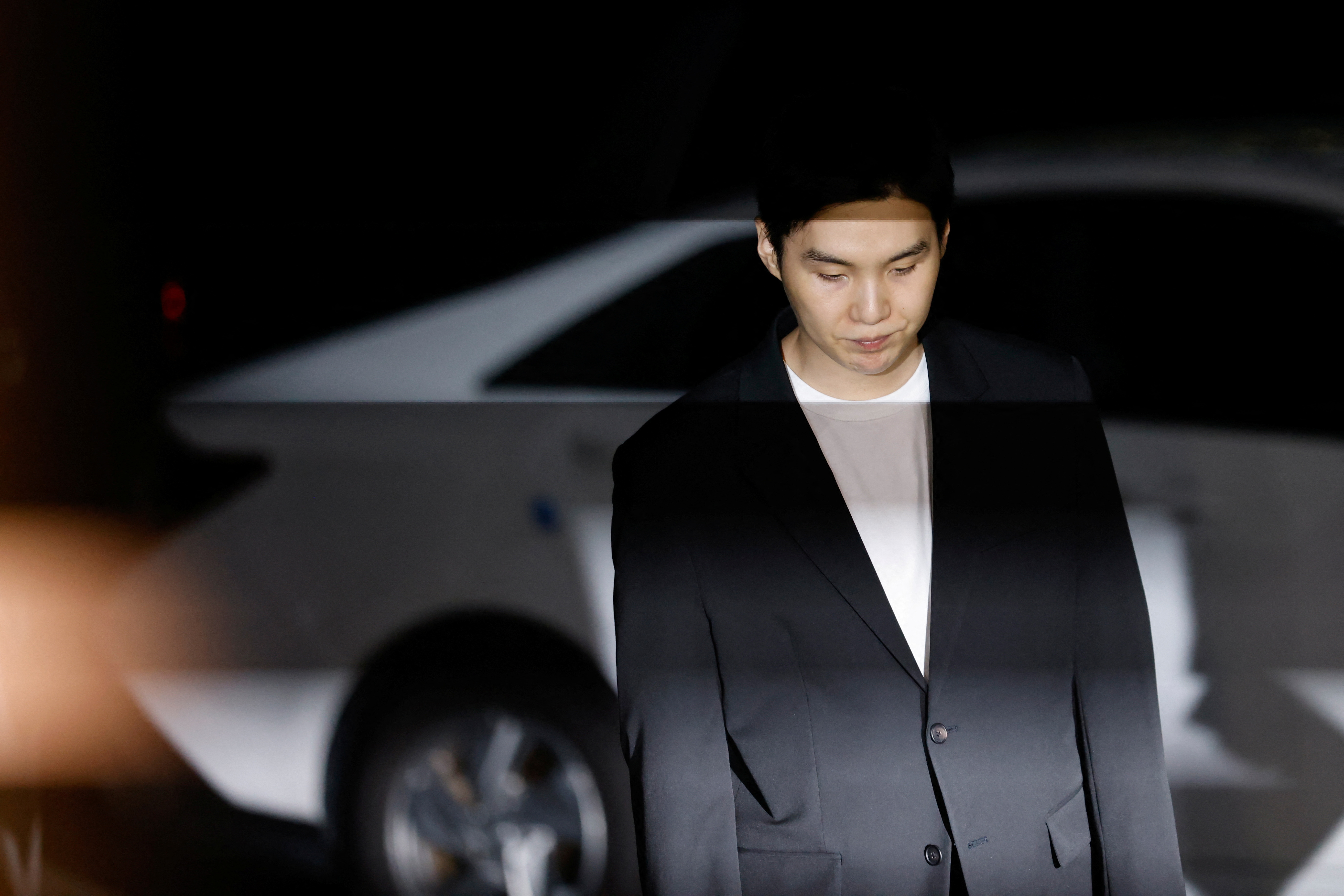Suga of the K-pop boy band BTS arrives at a police station for questioning regarding his drunk driving charge, in Seoul