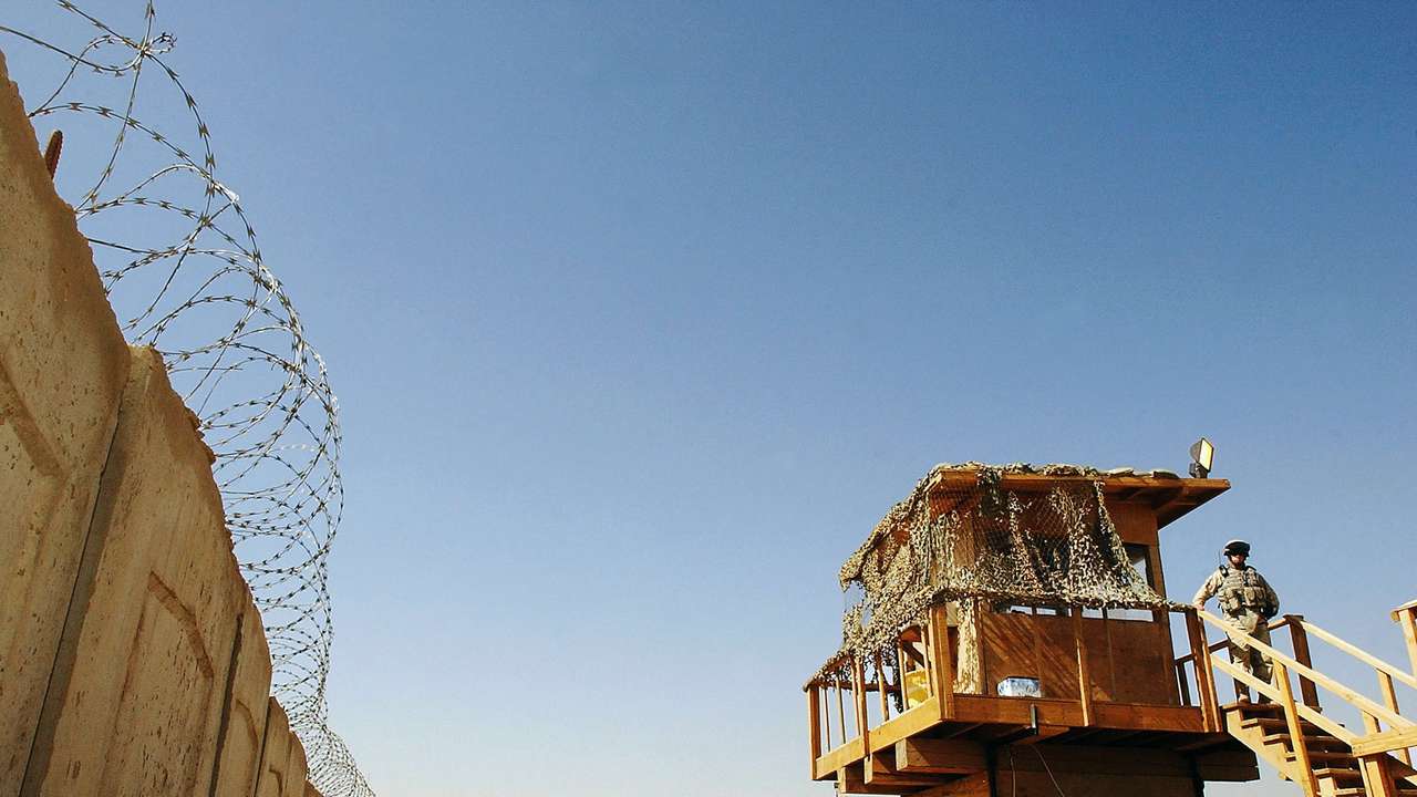 A US soldier stands guard at Abu Ghraib prison west of Baghdad
