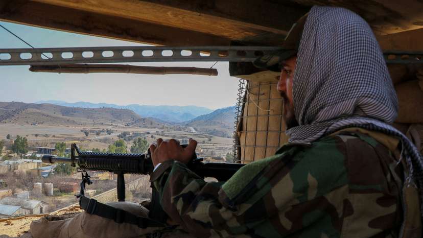 FILE PHOTO: A Taliban soldier keeps vigil from inside his post near the Pakistan-Afghanistan border, in Khost province