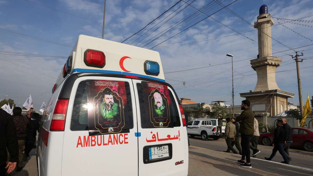 FILE PHOTO: Ambulances carry the coffins of Iraqi Shi'ite armed group members who were killed by a U.S. air strike in al-Qaim, during a funeral in Baghdad