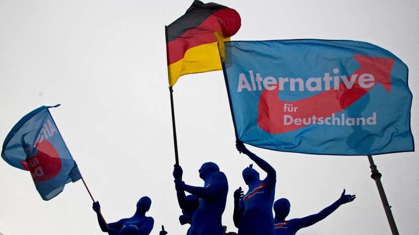 FILE PHOTO: Supporters of the AfD party wave flags during an event to rally support for Sunday's European Parliament elections in Berlin