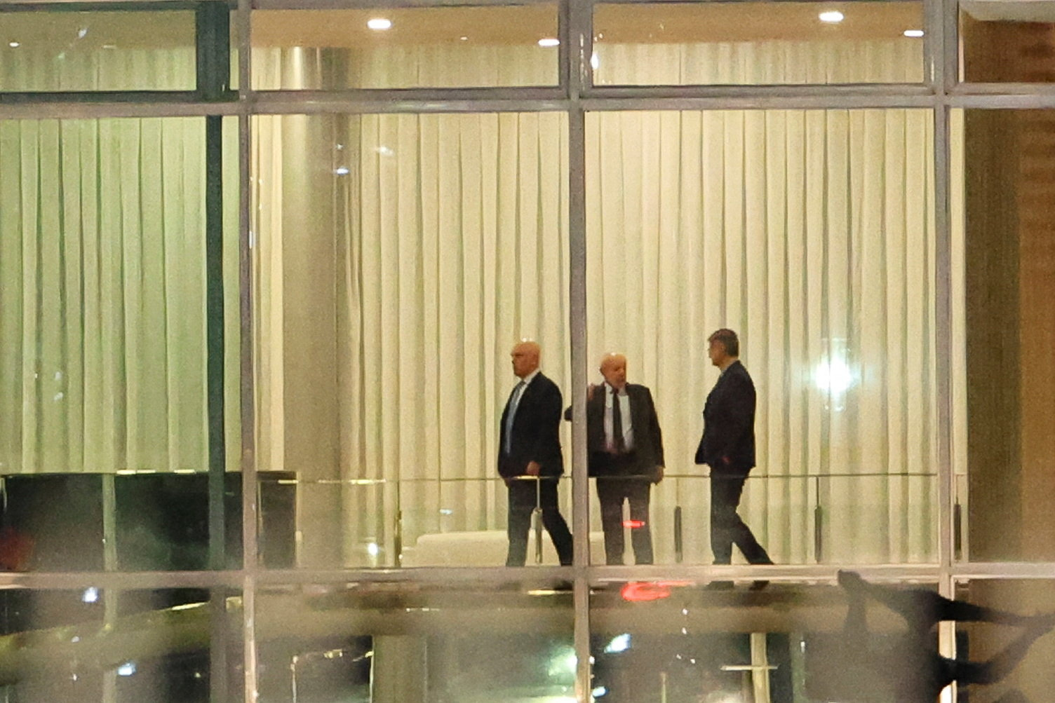 Brazil's Supreme Court Judge Alexandre de Moraes stands next to Brazil's President Luiz Inacio Lula da Silva and Brazil's Prosecutor General Paulo Gonet after a dinner at the Alvorada Palace in Brasilia