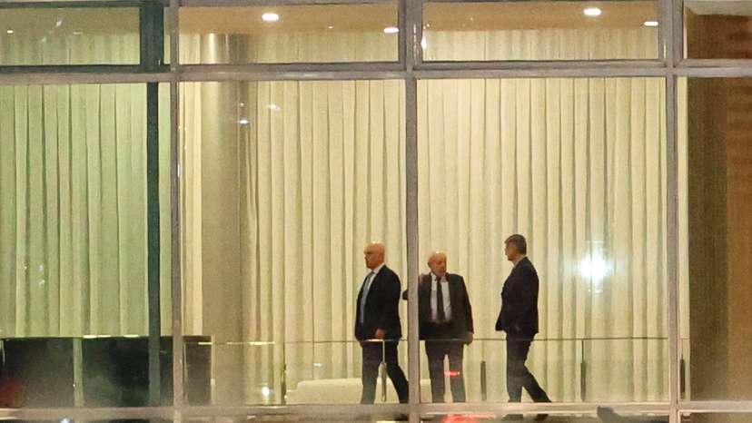 Brazil's Supreme Court Judge Alexandre de Moraes stands next to Brazil's President Luiz Inacio Lula da Silva and Brazil's Prosecutor General Paulo Gonet after a dinner at the Alvorada Palace in Brasilia