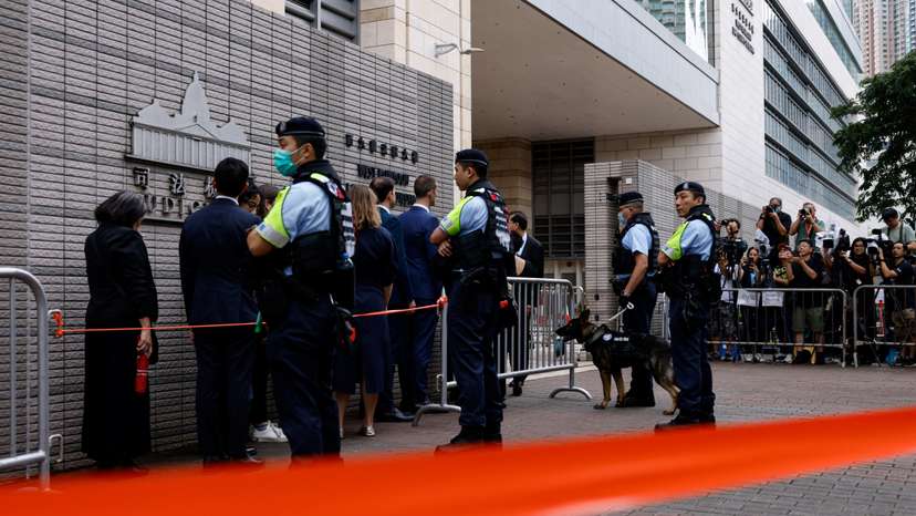 Police stand guard outside the West Kowloon Magistrates' Courts building, before the verdict of the 47 pro-democracy activists charged under the national security law, in Hong Kong