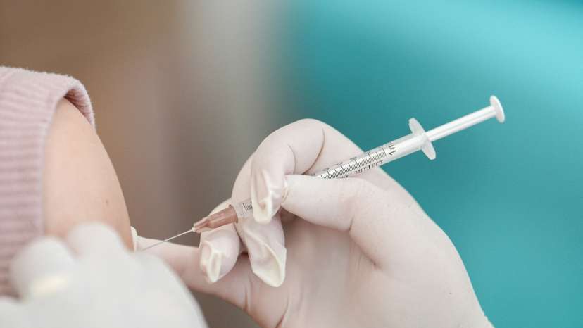 FILE PHOTO: A woman receives a booster dose of Pfizer-BioNTech vaccine against the coronavirus disease (COVID-19) at the Police hospital in Bangkok
