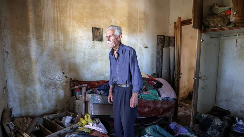 Vassilis Tsatsarelis, 80, stands among debris and his belongings at his damaged house, in the aftermath of Storm Daniel, in the village of Metamorfosi