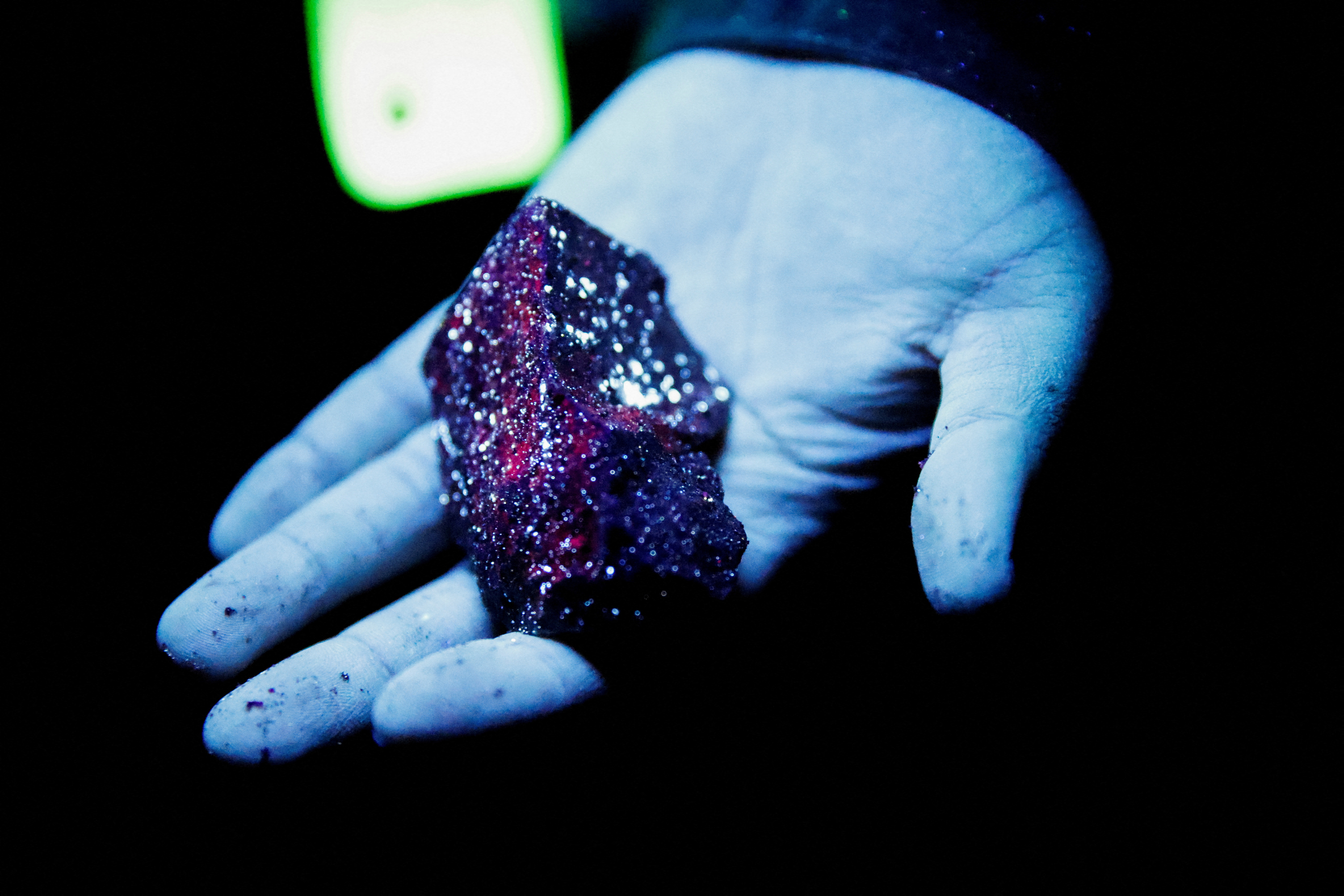 FILE PHOTO: Tungsten is illuminated with mineral light in a mine in Gangwon Province