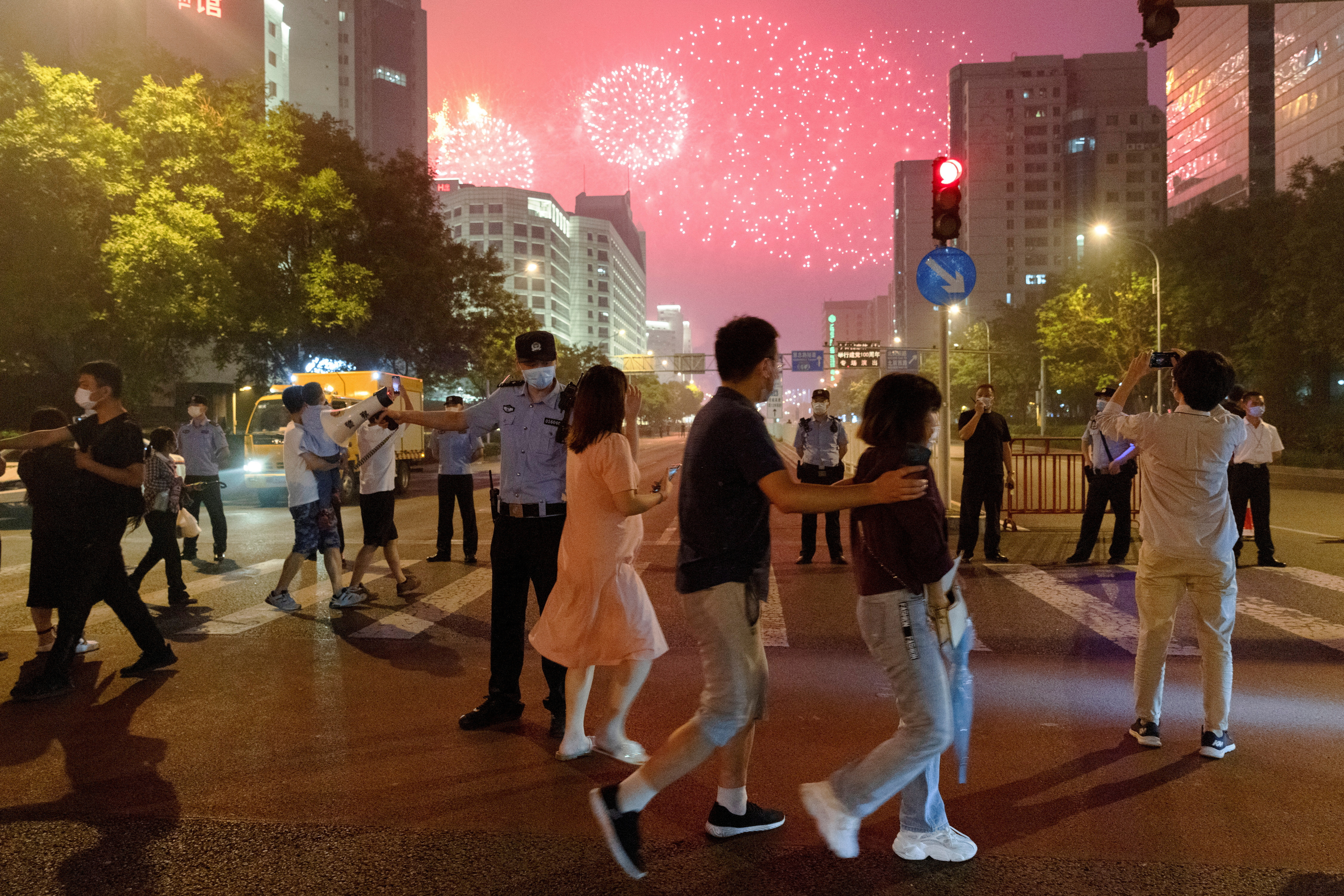 FILE PHOTO: FILE PHOTO: People watch a rehearsal of a fireworks display near the National Stadium ahead of the 100th founding anniversary of the Communist Party of China in Beijing