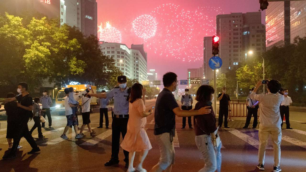 FILE PHOTO: FILE PHOTO: People watch a rehearsal of a fireworks display near the National Stadium ahead of the 100th founding anniversary of the Communist Party of China in Beijing