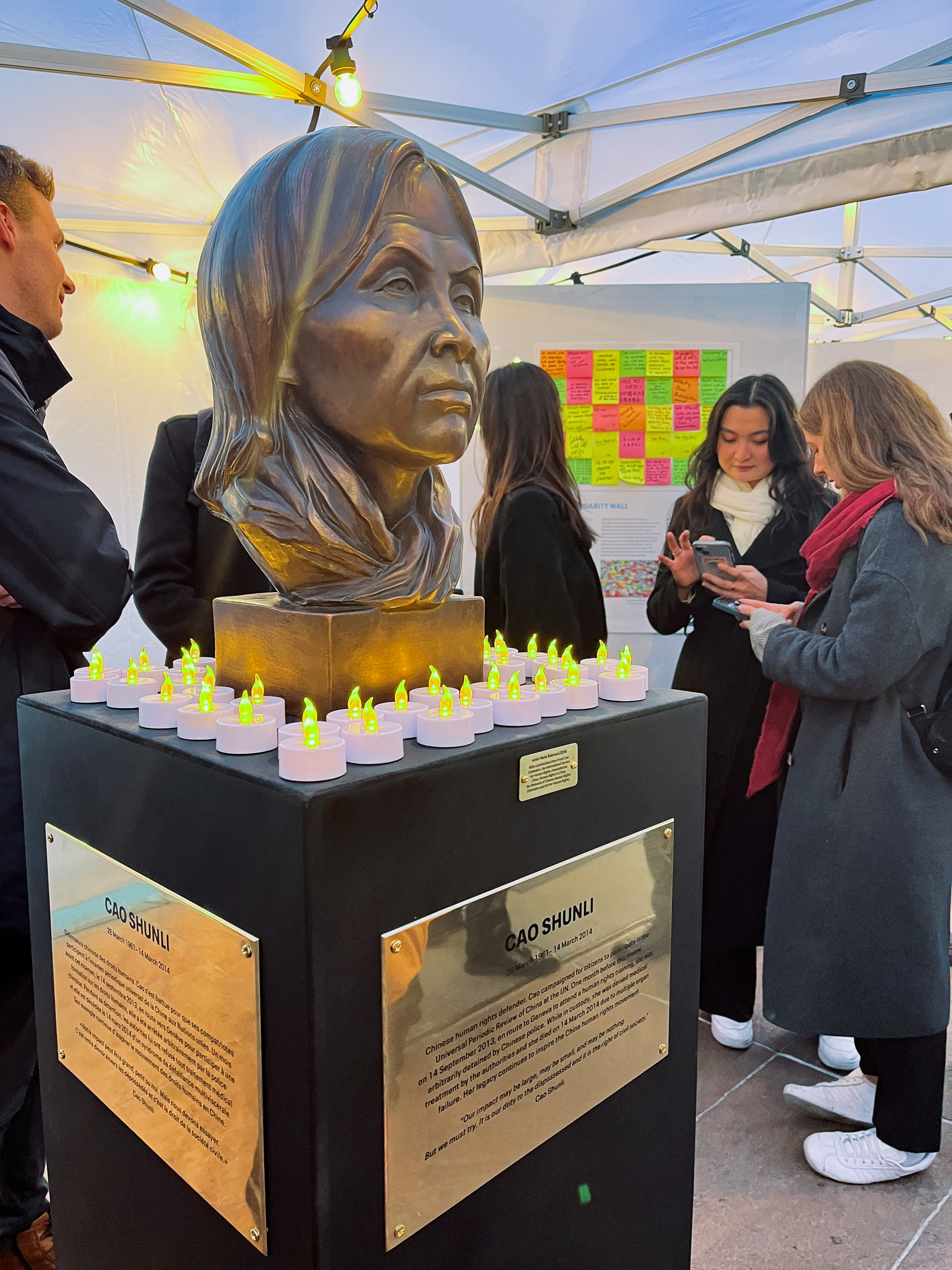 A statue of late Chinese human rights activist Cao Shunli is seen surrounded by candles at a reception, in Geneva