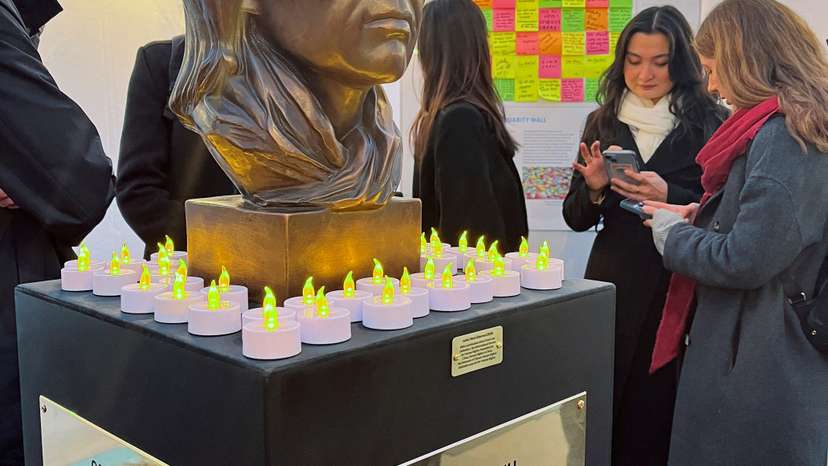 A statue of late Chinese human rights activist Cao Shunli is seen surrounded by candles at a reception, in Geneva