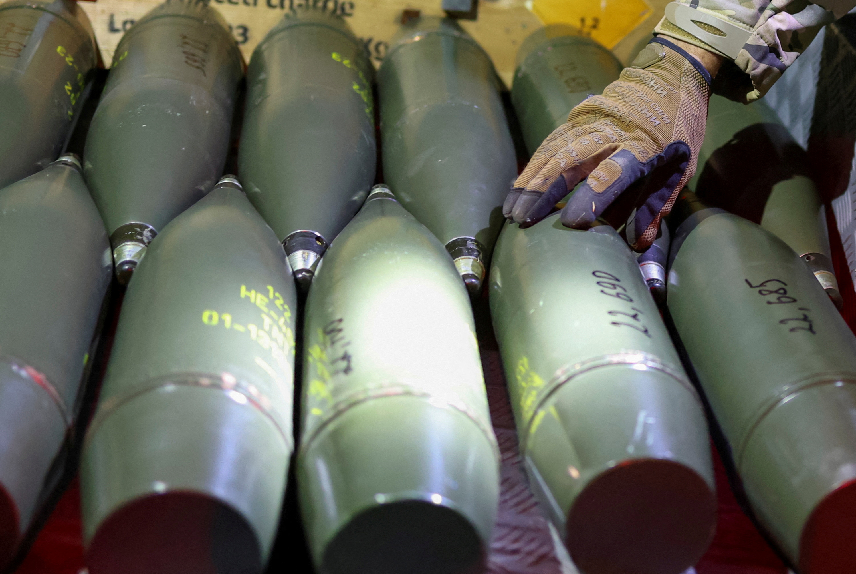 FILE PHOTO: Ukrainian serviceman checks artillery shells in southern Ukraine