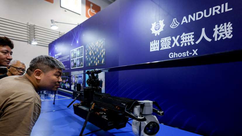 FILE PHOTO: Visitors look at the Ghost-X unmanned aerial vehicle developed by U.S. company Anduril