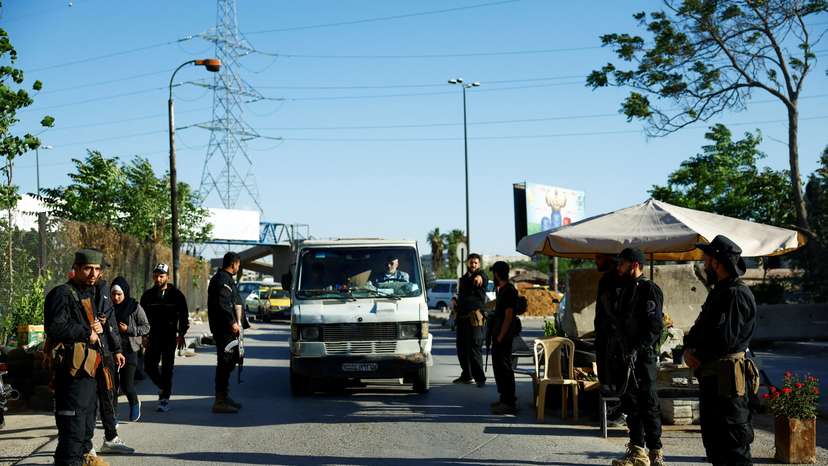Syrian security forces stand together, following deadly clashes between Sunni fighters against armed Druze residents in Jaramana