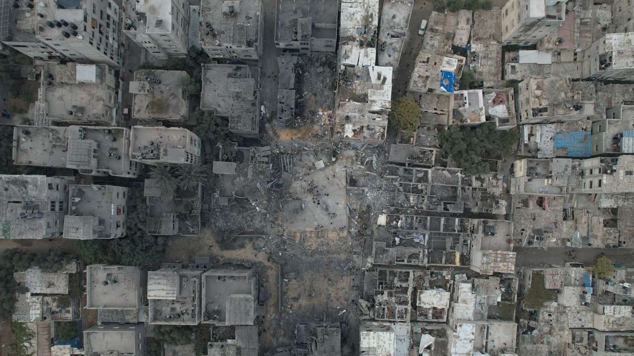 A view of the remains of a mosque and houses destroyed by Israeli strikes in the central Gaza Strip
