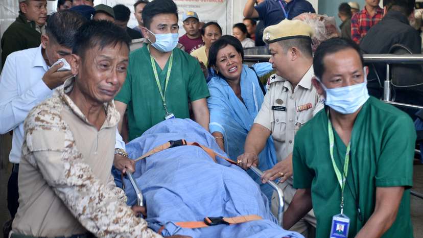 Relatives and police officers mourn as they carry the body of Chingtham Anand, a SDPO, outside a hospital in Imphal