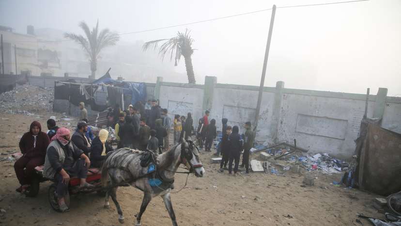 Palestinians inspect the damage to a tent for displaced people, after an Israeli airstrike, in Khan Younis